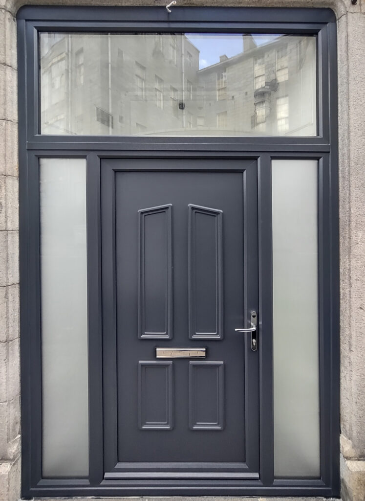 StormMeister® uPVC Inward Opening Flood Door, colour - Grey, Solid Panel - Windsor, polished silver Handle - polished silver letter box. Fitted with the StormMeister® Active Flood Seal.